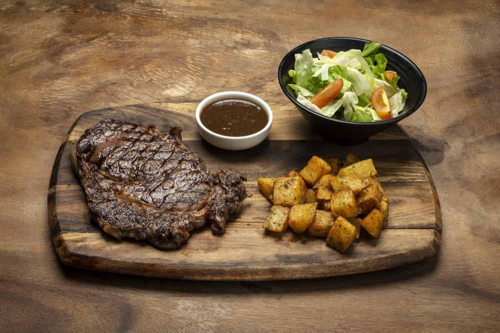Grilled ribeye steak and fries at Bouchon Wine Bar