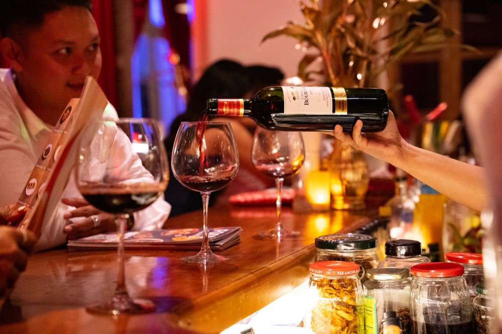 Wine being poured for a guest at Bouchon Wine Bar